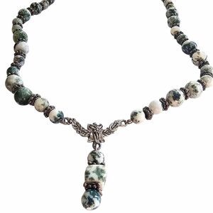 Elegant artisan necklace featuring natural moss agate beads with a unique